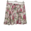 Minifalda plisada para chica en tejido poliéster con estampado de flores rosas sobre fondo claro, diseño corto y juvenil, con