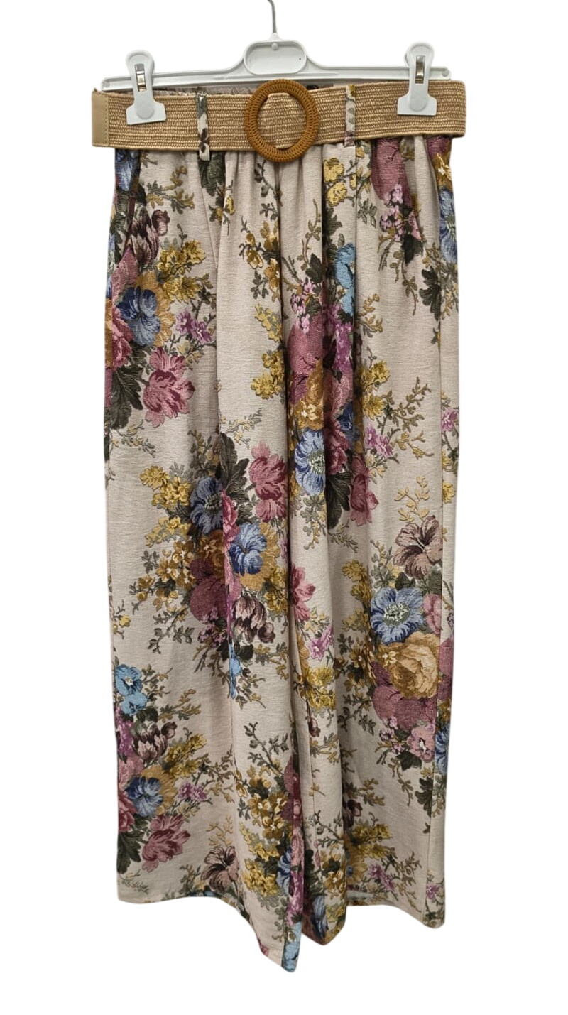 Falda larga de flores para chica en tonos rosas, azules y amarillos sobre fondo claro, con cintura alta y cinturón trenzado