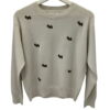 Jersey fino de chica en color beige con cuello redondo de canalé, mangas largas y bordados de pequeños perritos en contraste