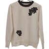 Jersey bicolor de mujer en color marfil con cuello negro y aplicaciones de flores de felpa negras, mangas largas y ajuste hol