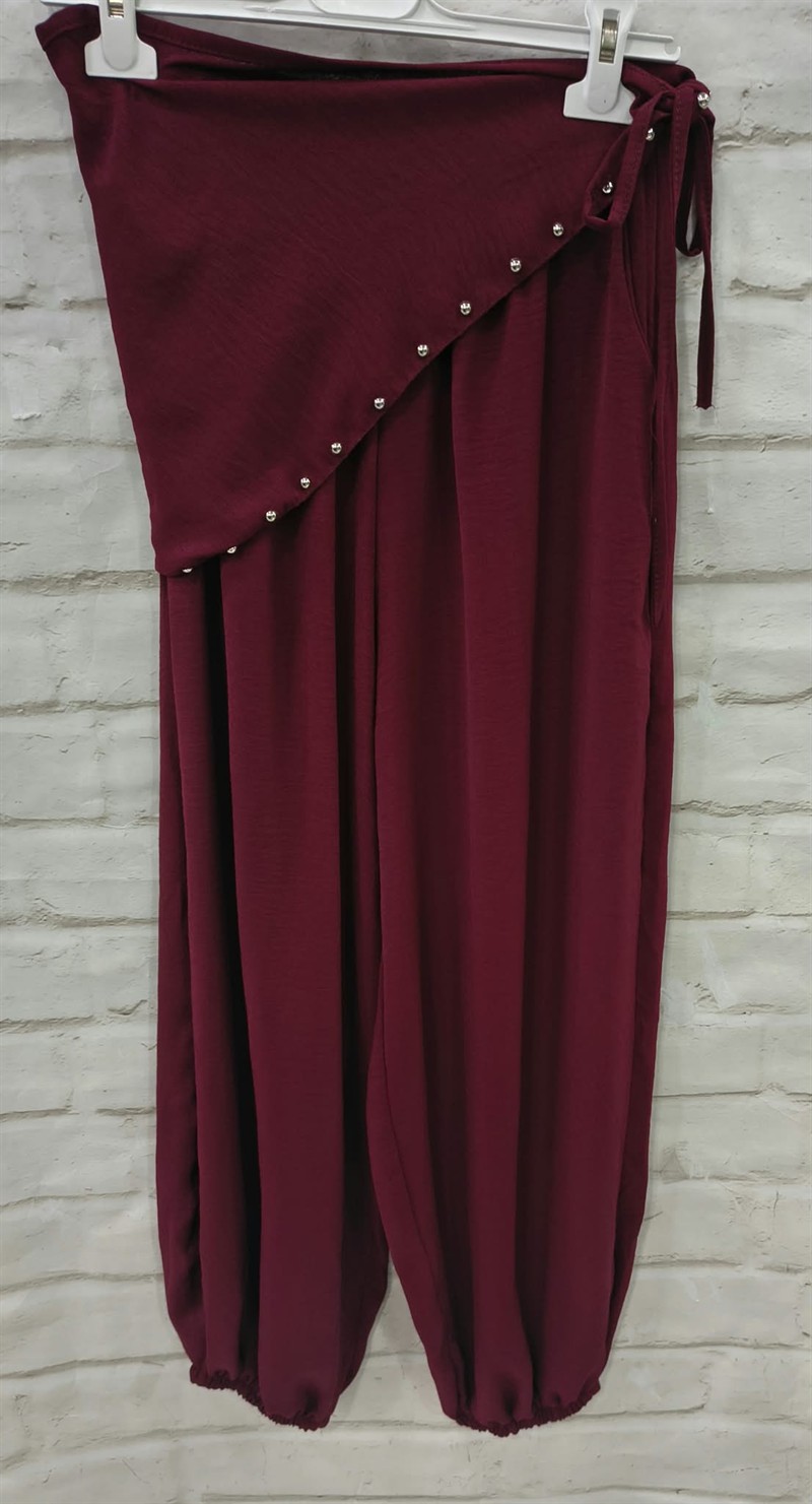 Pantalón bombacho con pareo de tachas